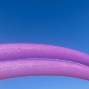 Two purple curved lines against a blue sky.