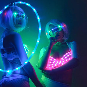 Two women in neon rave outfits
