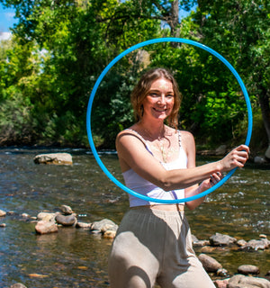 Woman with blue hoop near river