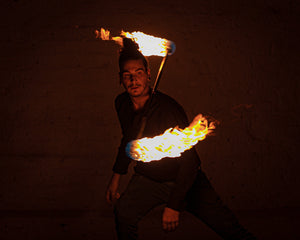 Fire performer spinning a MoonBlaze fire staff