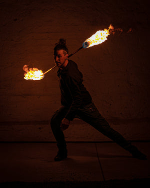 Fire performer with a MoonBlaze fire staff
