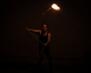 Fire rope dart performer spinning a MoonBlaze head.