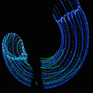 Blue and green light trails against black background.