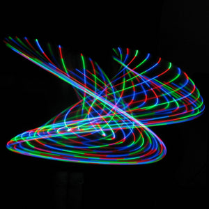 Colorful light trails against black background.