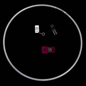 White hoop and small electronic components on black background.