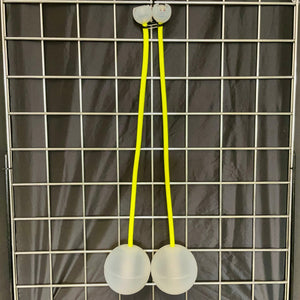 Two white balls connected by yellow strings.