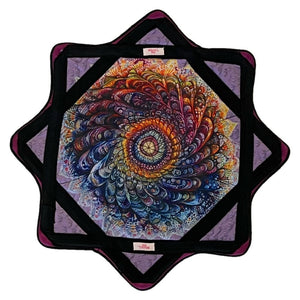 Colorful spiral design on a quilted, star-shaped pillow.
