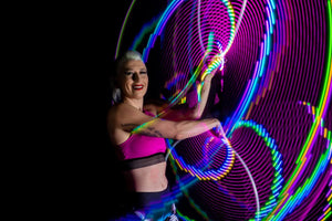 Woman with glowing LED hoops