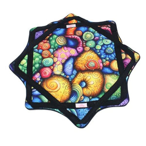 Colorful abstract quilted trivet with black border.