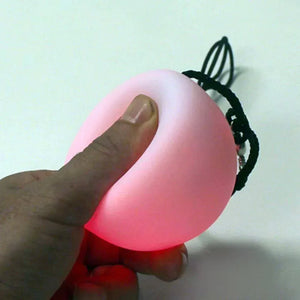 Pink glowing ball held in hand