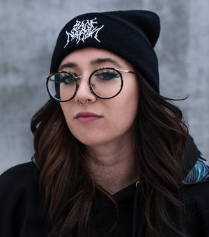 Woman in black beanie and glasses