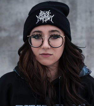 Woman wearing black beanie and glasses