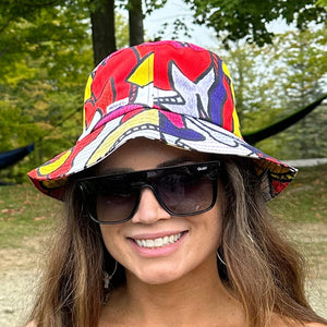 Woman wearing colorful bucket hat and sunglasses