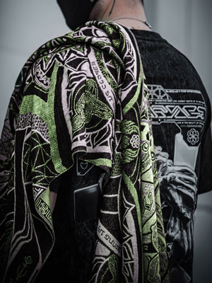 Green shawl with intricate pattern draped over person's back