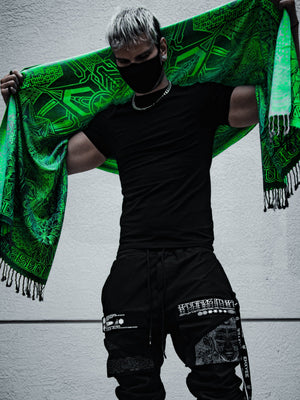 Man in black holding green shawl