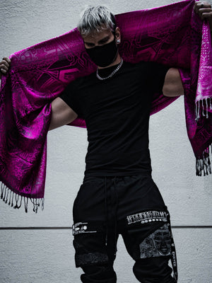 Man in black holding pink shawl