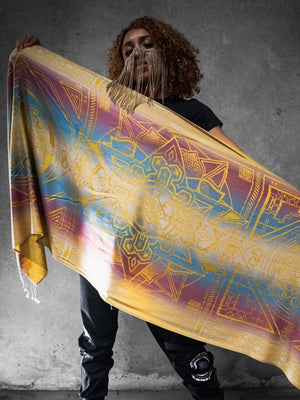 Woman holding yellow dharma shawl with mandala design