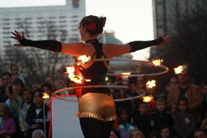 Fire dancer performing with flaming hoops