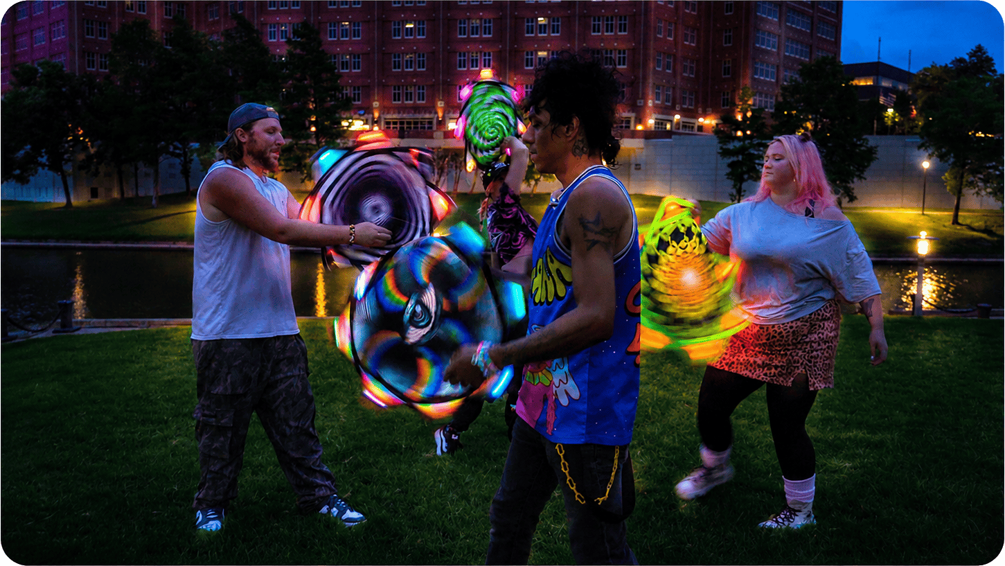 Flow artists spinning Ultra LED Flow Stars outdoors at night