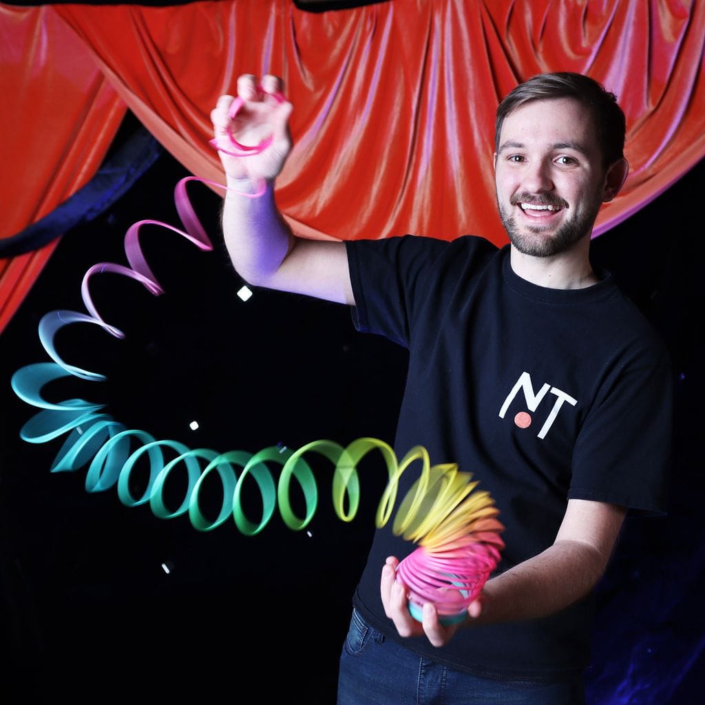  Man playing with rainbow slinky 